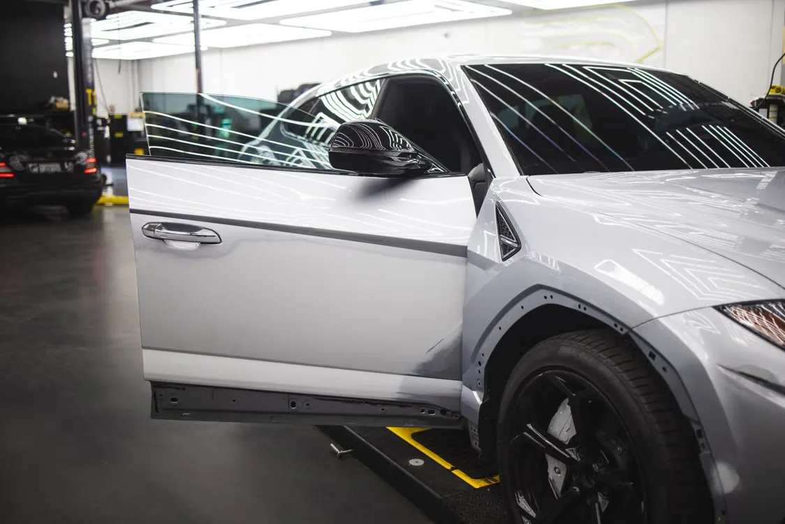 Silver sports coupe inside a bright automotive studio