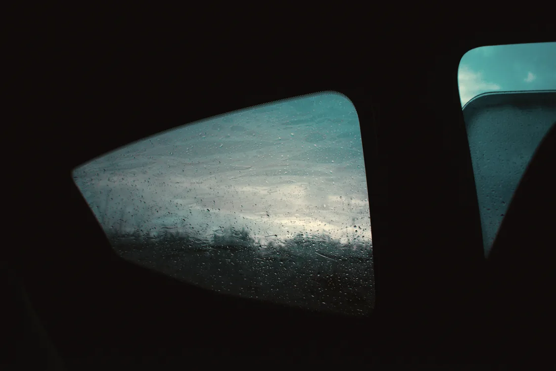 View out through a tinted side window from inside a darkened cabin