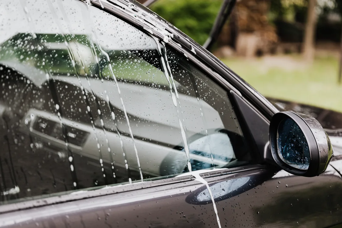 Window film being fitted to a car side window